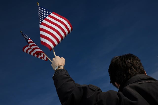 Man burns U.S. flag near White House to protest Trump order