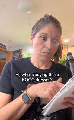 Older generation woman looking at a notebook as if it were a phone with wide eyed disbelief. Text overlay reads, "Hi, who is buying these HOCO dresses?"