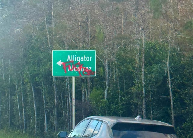 “Fuck ICE” Tag Spray Painted on Alligator Alcatraz Signs