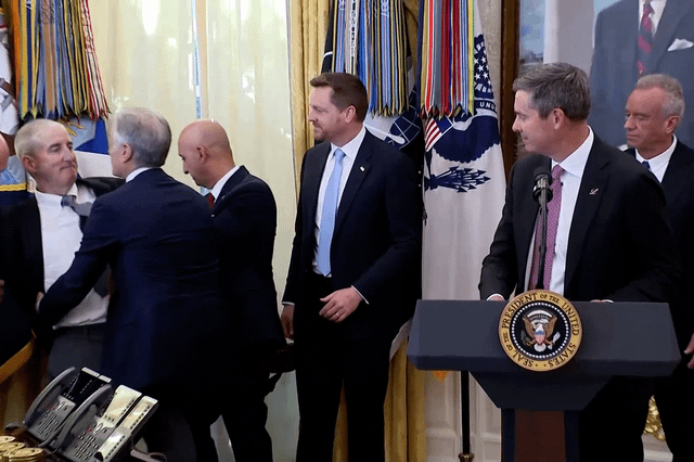 Pharma executive passes out in Oval Office while standing behind Trump during event