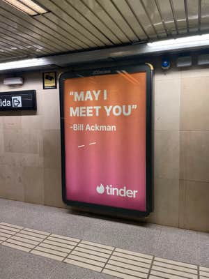 Tinder subway ad reading "'MAY I MEET YOU'."