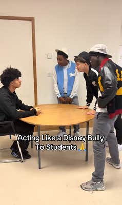 Group of "bullies" making fun of another person sitting at a round table at a school.