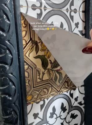 @leahsetherealcottage/TikTok peeling up a vinyl sticker to reveal vintage tile. “Look what we uncovered in our little 1826 English cottage today!!!!”