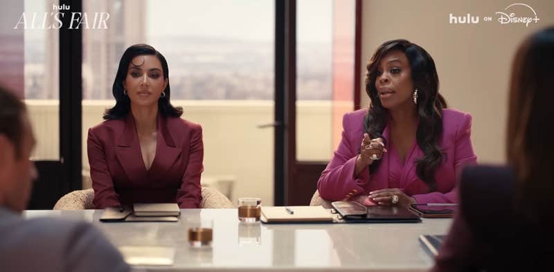 Kim Kardashian and Nicey Nash at a board room table.