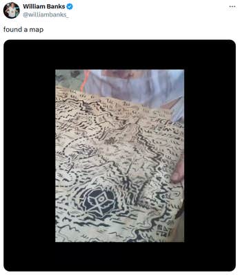 Tweet reading "found a map" with a video showing someone holding an elaborate treasure map.