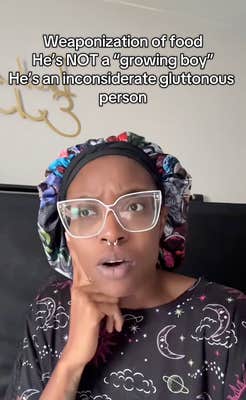 A woman wearing big glasses with her finger to her chin, staring off to one side as she tells her story to the camera.