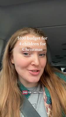 Redheaded woman sitting in her car, smiling. Text overlay reads, "$100 budget for 4 children for Christmas."