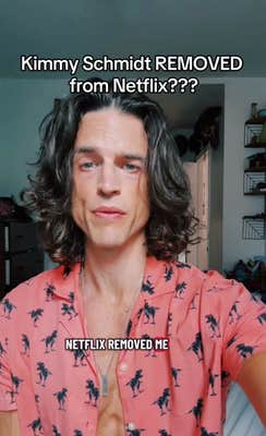 An actor with long hair and a chiseled jaw talking to the camera. Text overlay reads, "Kimmy Schmidt REMOVED from Netflix???"