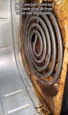 @welcometheekidd/TikTok looking inside an air fryer appliance with onscreen text: “POV: you just found out the inside of an air fryer is just one stove plate,” as dramatic music played.