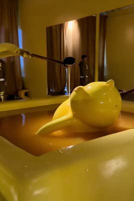 @peachyphu/TikTok, Butter Baby mascot bathing in a pool filled with butter