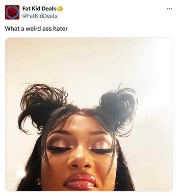 Tweet that reads, "What a weird a** hater" with a photo of a Black woman with space buns and a full face of makeup staring down at the camera in disgust.