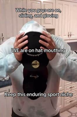 TikTok video of someone holding a hat with their mouth with a caption reading "While you guys are on sliding and gloving, WE are on hat mouthing. Keep this enduring sport niche."