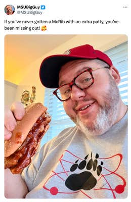 Tweet that reads, "If you’ve never gotten a McRib with an extra patty, you’ve been missing out! 🥰" with a photo of a smiling man in a red baseball cap and grey t-shirt holding up a double McRib sandwich.