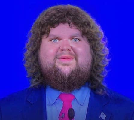 JD Vance Photoshop meme showing him with a large face and a mane of curly hair.