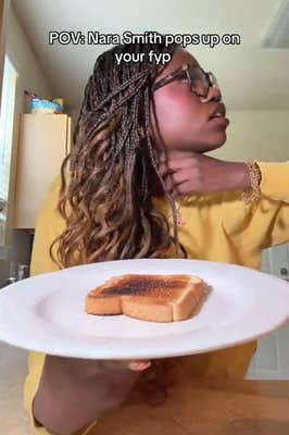 TikTok video of a woman holding a white plate with a piece of toast on it while choking herself. The caption reads ""POV: Nara Smith pops up on your fyp"
