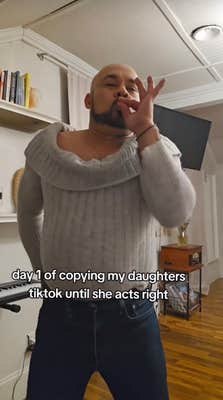 Dad in daughter's sweater pretending to smoke weed.