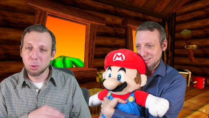 Greenscreened image of a man talking to the camera while showing a photo of him awkwardly holding his Mario plushie in a similar way to the Nintendo ad's hand, thumb bent backward.