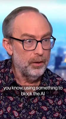 An older white man with a beard and thick glasses talking in an interview. Text overlay reads, "you know, using something to block the AI."